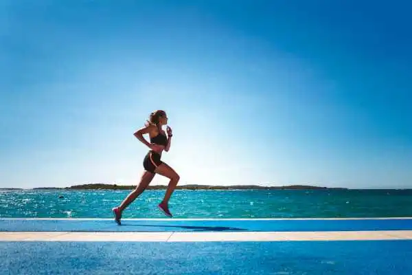 Woman running showing strong leg muscle Alton